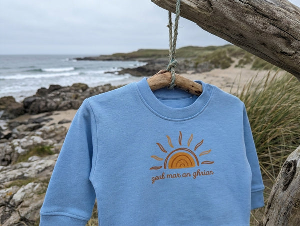 blue sweatshirt with sun design
