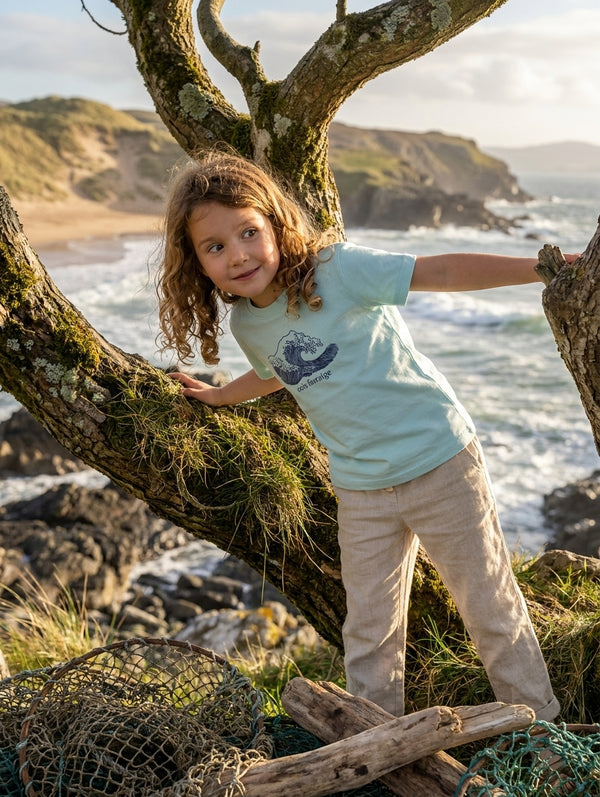 Styled editorial photo of poolblue kids t-shirt with wave illustration