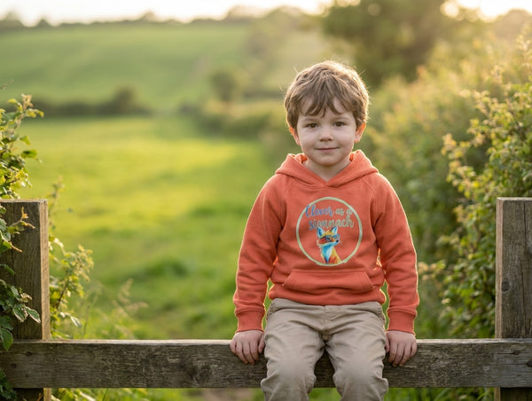 Child wearing orange hoodie with fox design, portrait