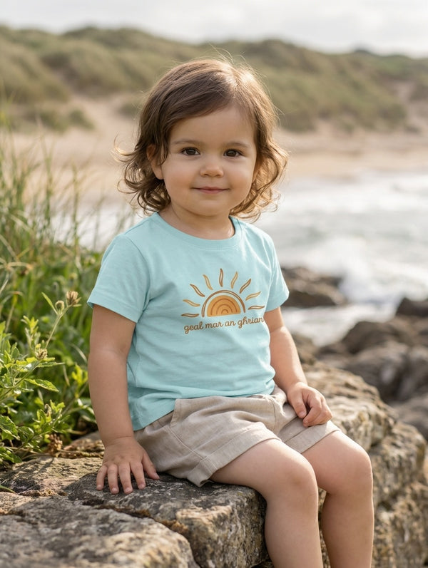 Child wearing blue t-shirt with sun design, portrait
