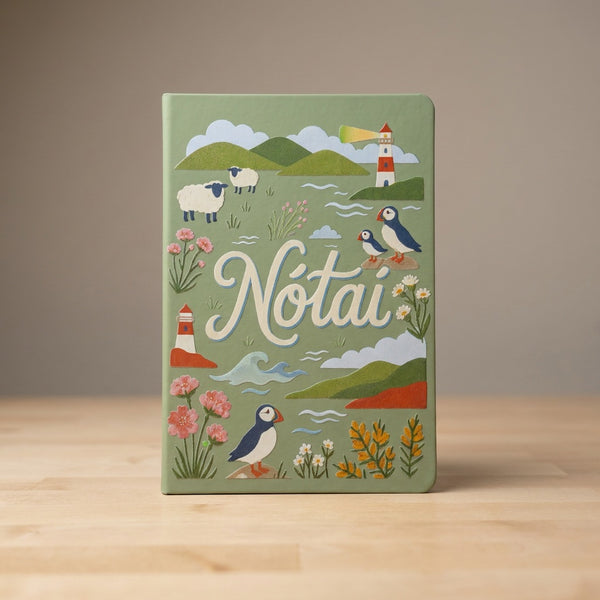 Close-up of the sage green Nótaí cover: puffins, sheep, a lighthouse, sea thrift and gorse