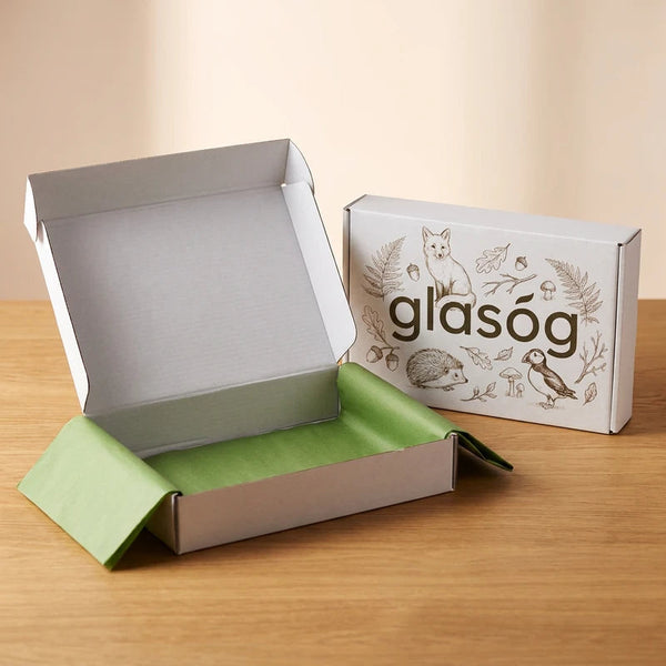 Glasóg printed woodland gift box, open with green tissue paper
