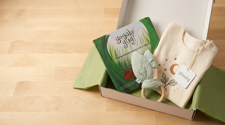 Glasóg woodland gift box packed with an Irish picture book, baby garment and wooden rattle