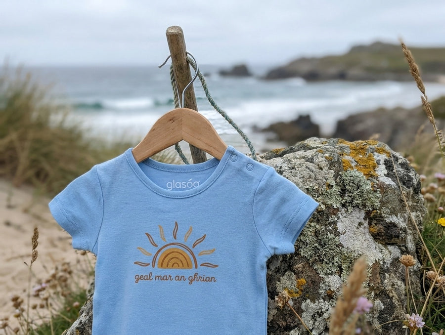 blue bodysuit with sun design