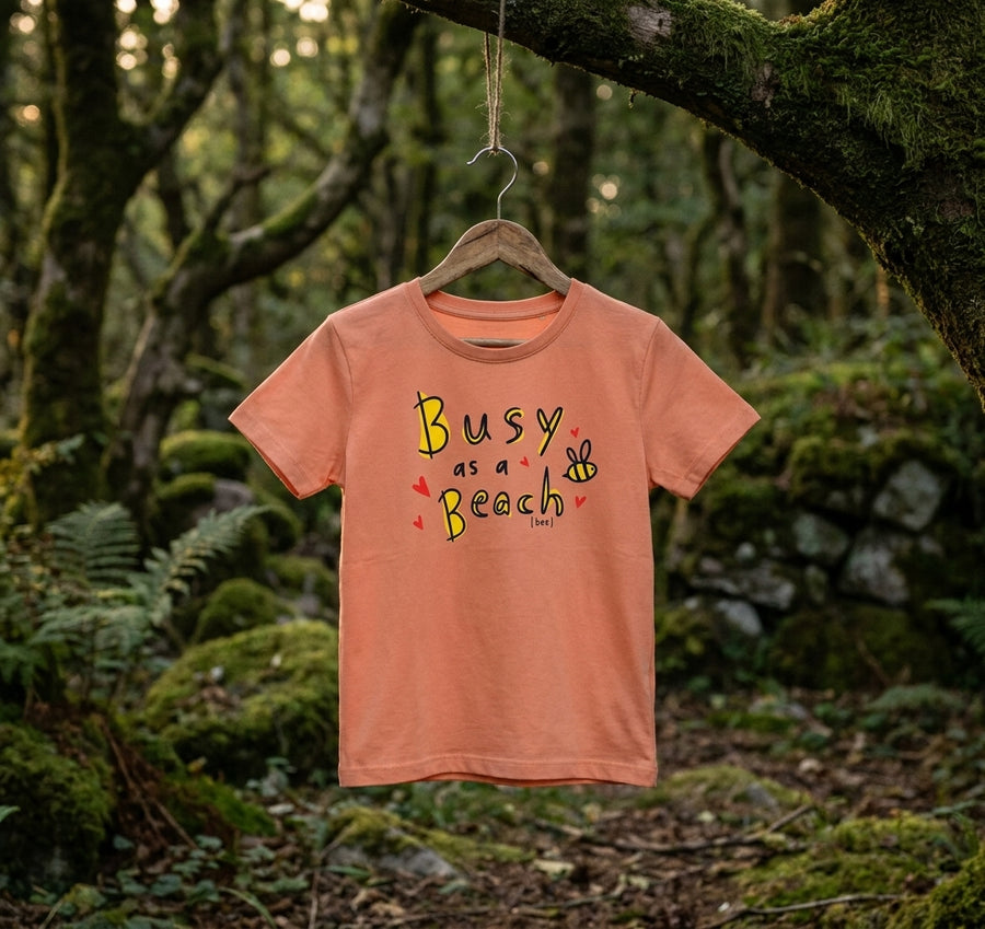 peach kids t-shirt with bee design hanging outdoors in Irish woodland