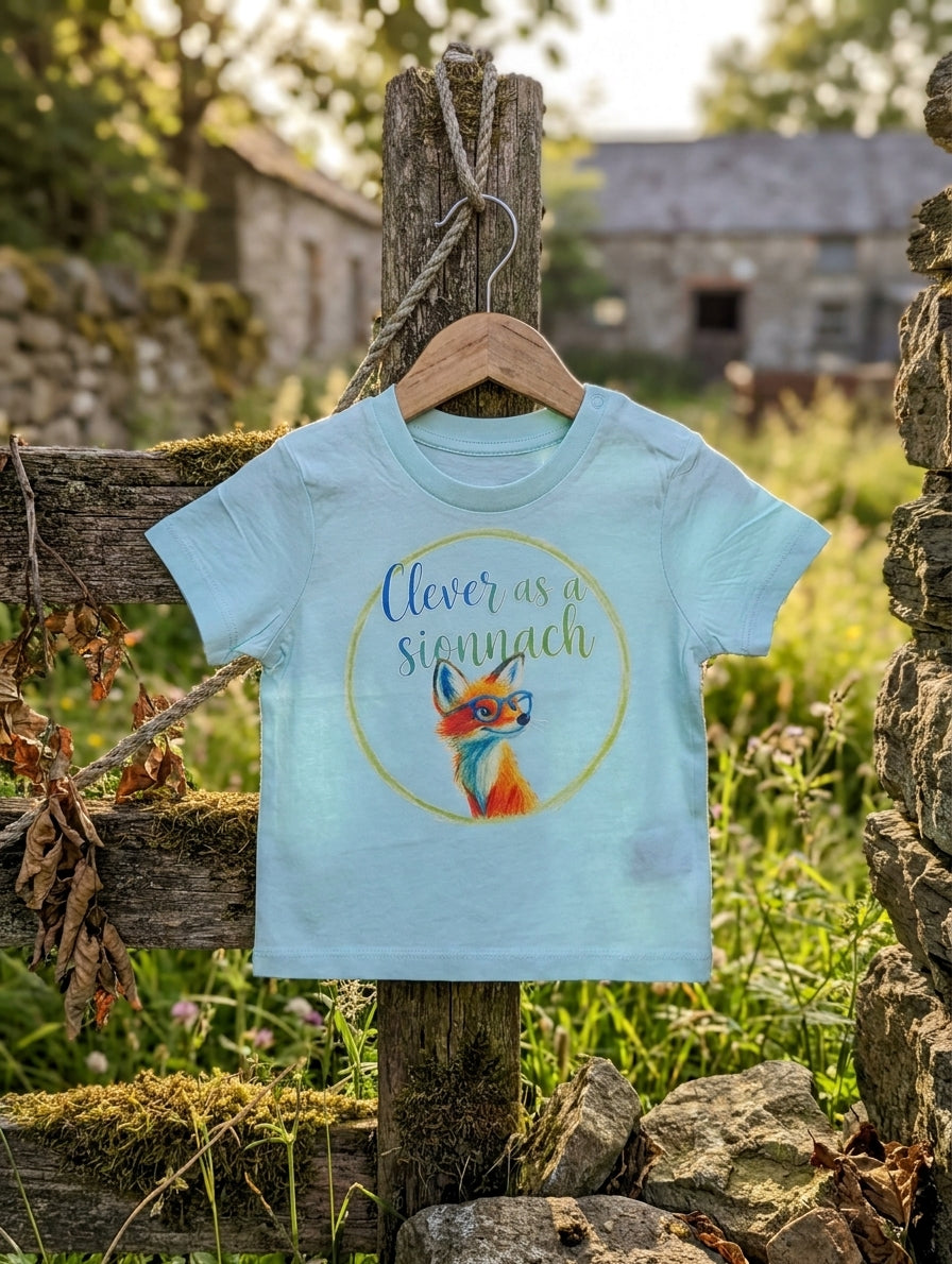 Blue baby t-shirt with fox design on a hanger outdoors