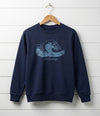 navy kids sweatshirt with wave design hanging on wooden shiplap wall