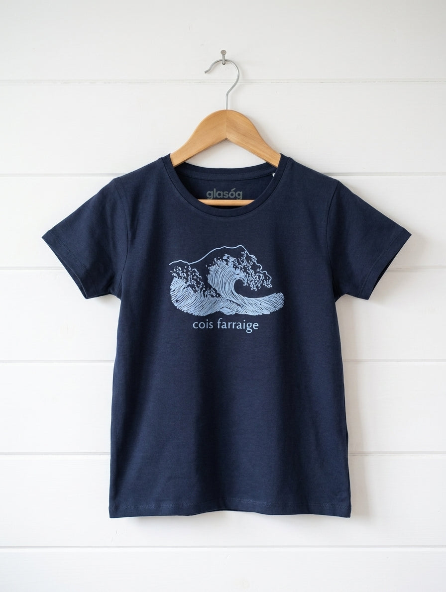 navy kids t-shirt with wave design hanging on wooden shiplap wall