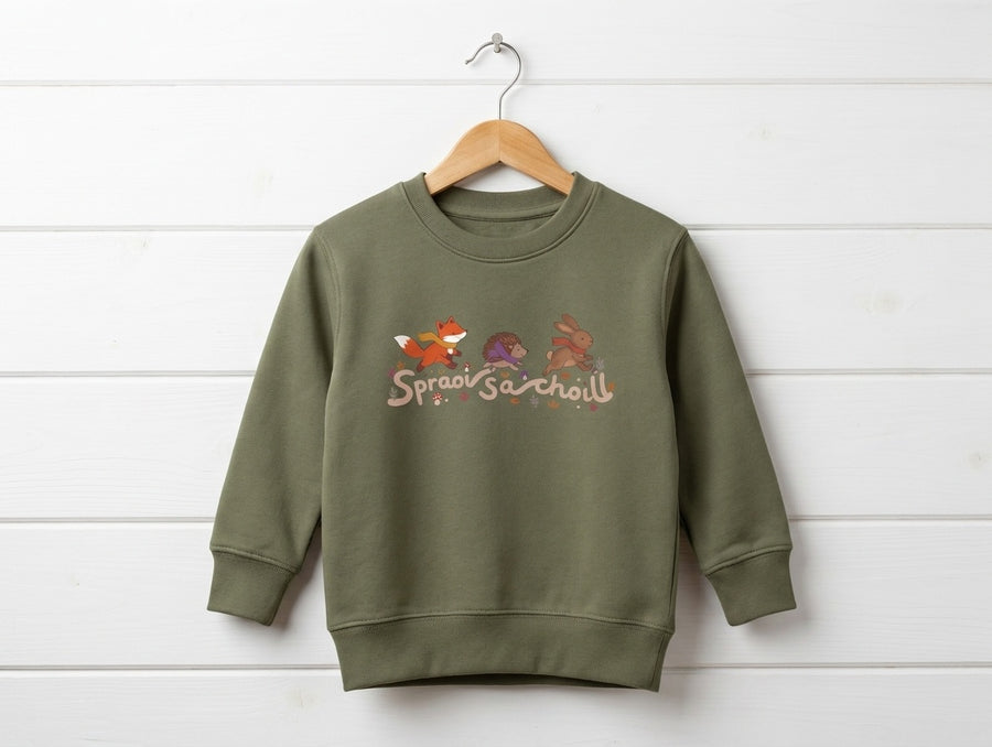 khaki kids sweatshirt with spraoisachoill design hanging on wooden shiplap wall