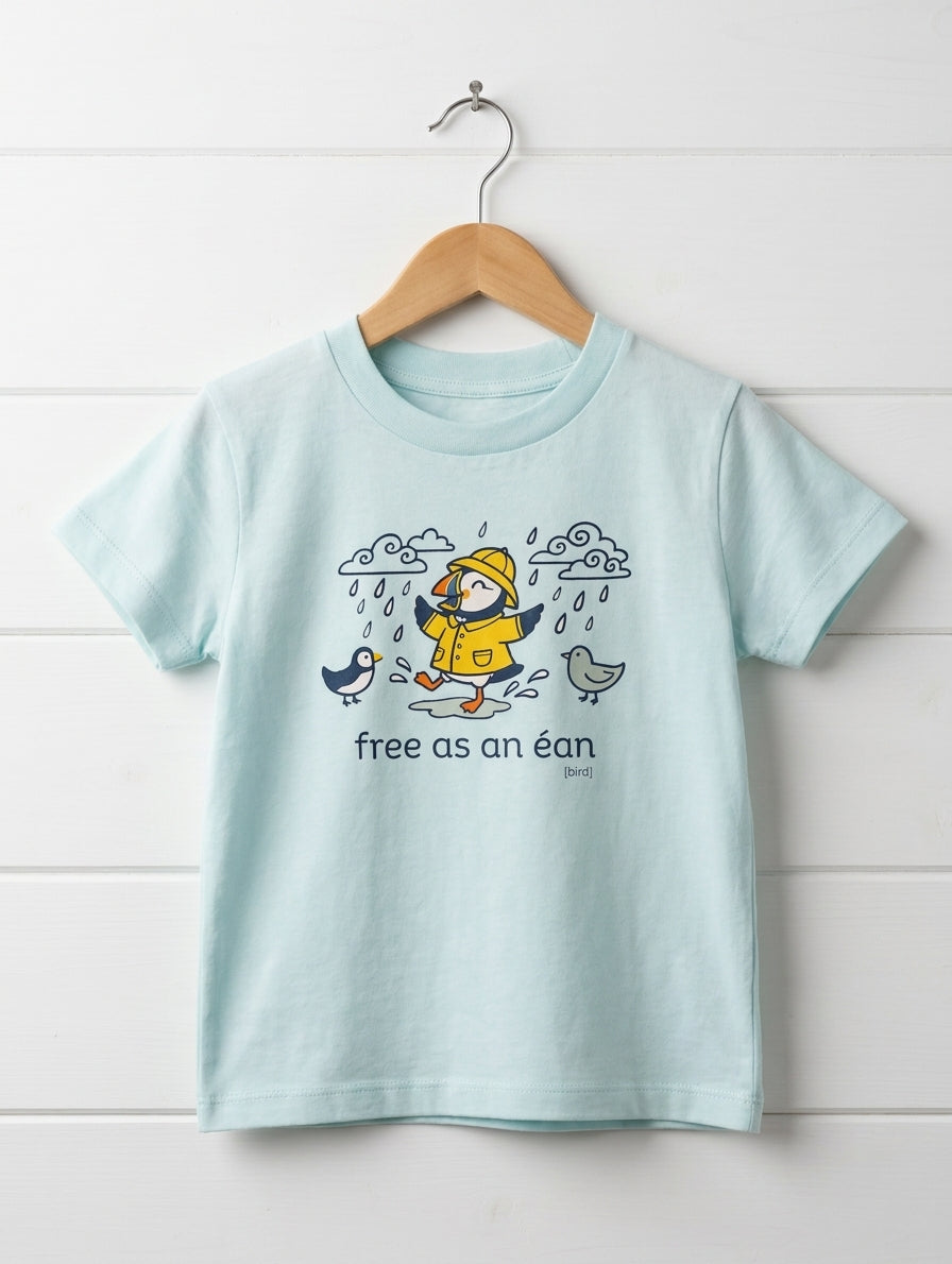 blue kids t-shirt with puffin design hanging on wooden shiplap wall