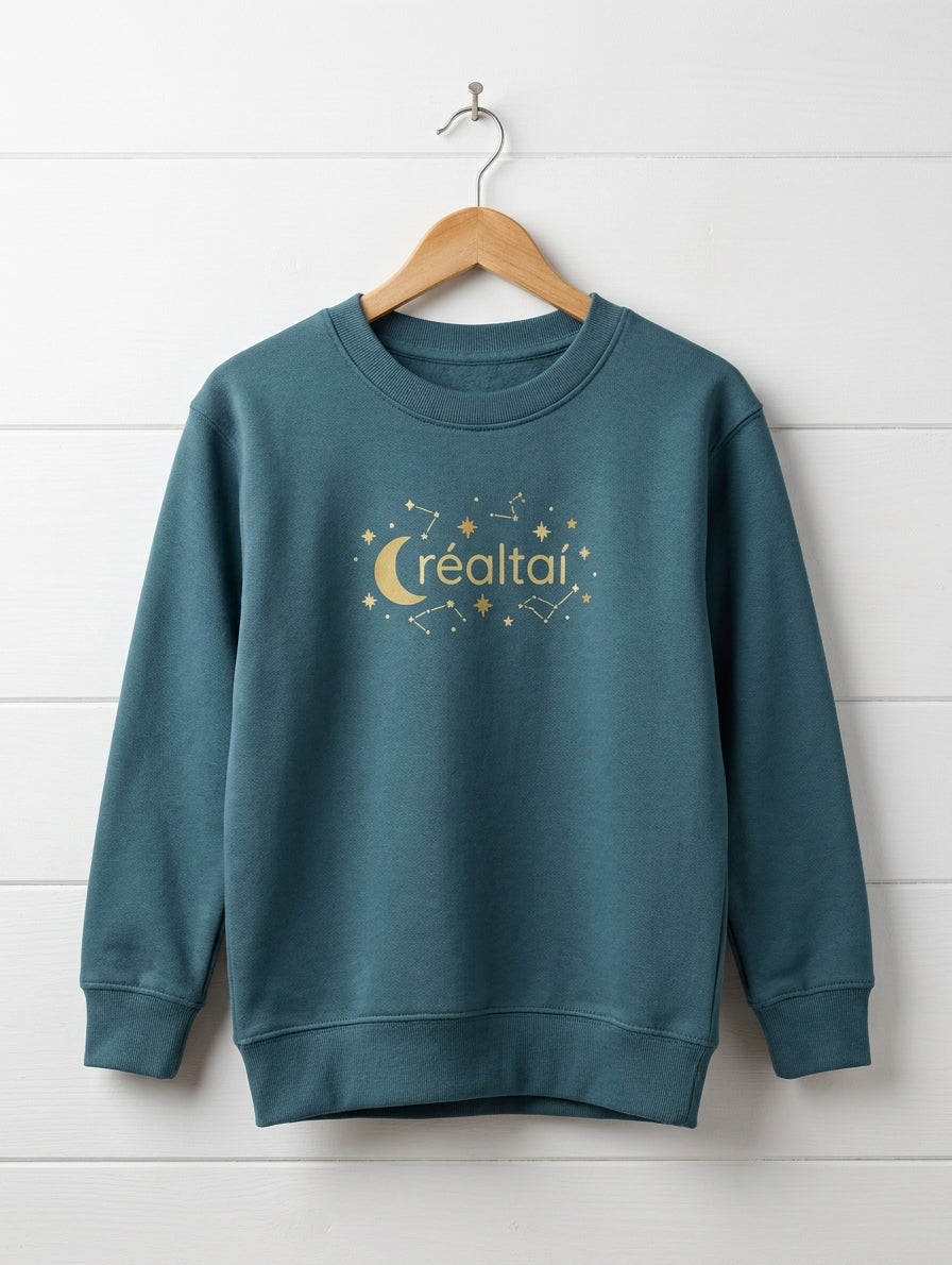 twilight blue sweatshirt with stars design hanging on wooden shiplap wall