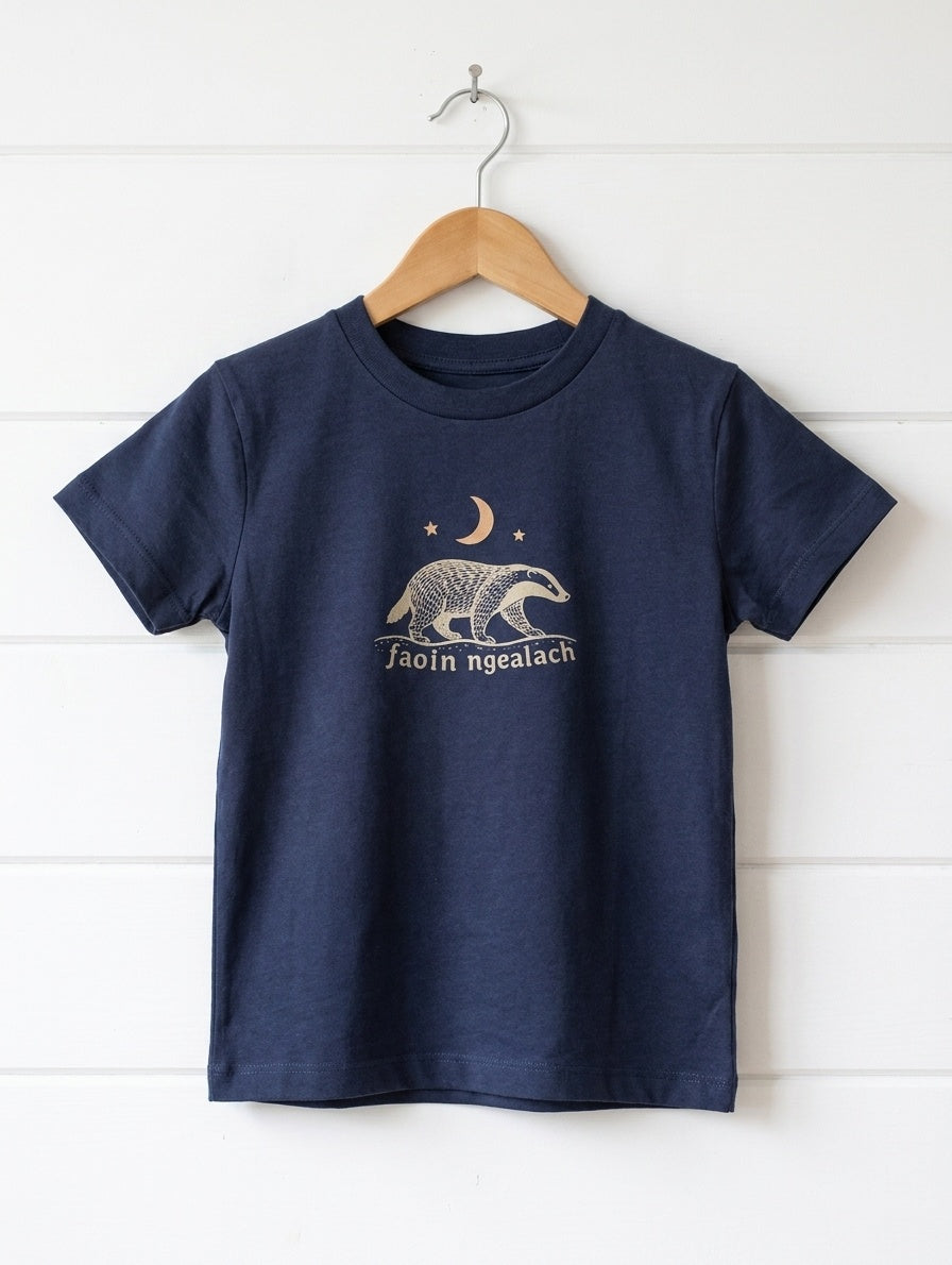 navy kids t-shirt with faoin-ngealach design hanging on wooden shiplap wall