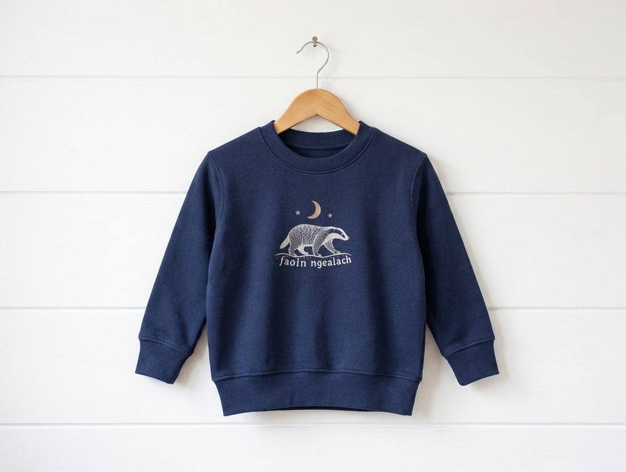 navy sweatshirt with Faoin nGealach design hanging on wooden shiplap wall