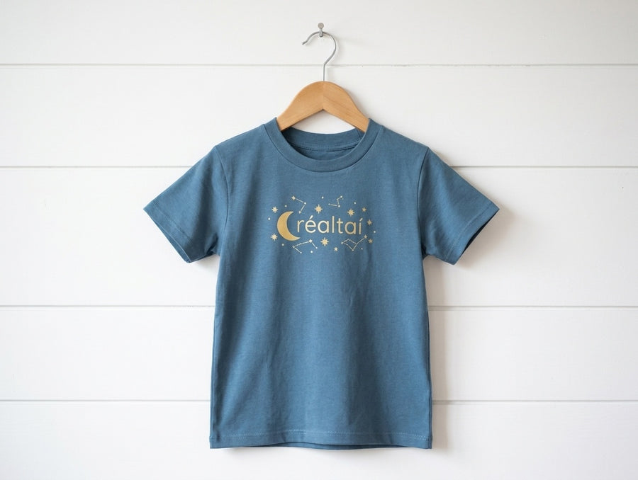 twilightblue kids t-shirt with stars design hanging on wooden shiplap wall