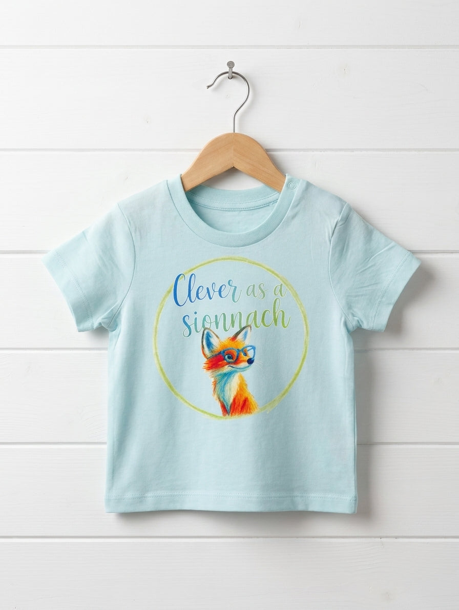 Blue baby t-shirt with fox design hanging on wooden shiplap wall