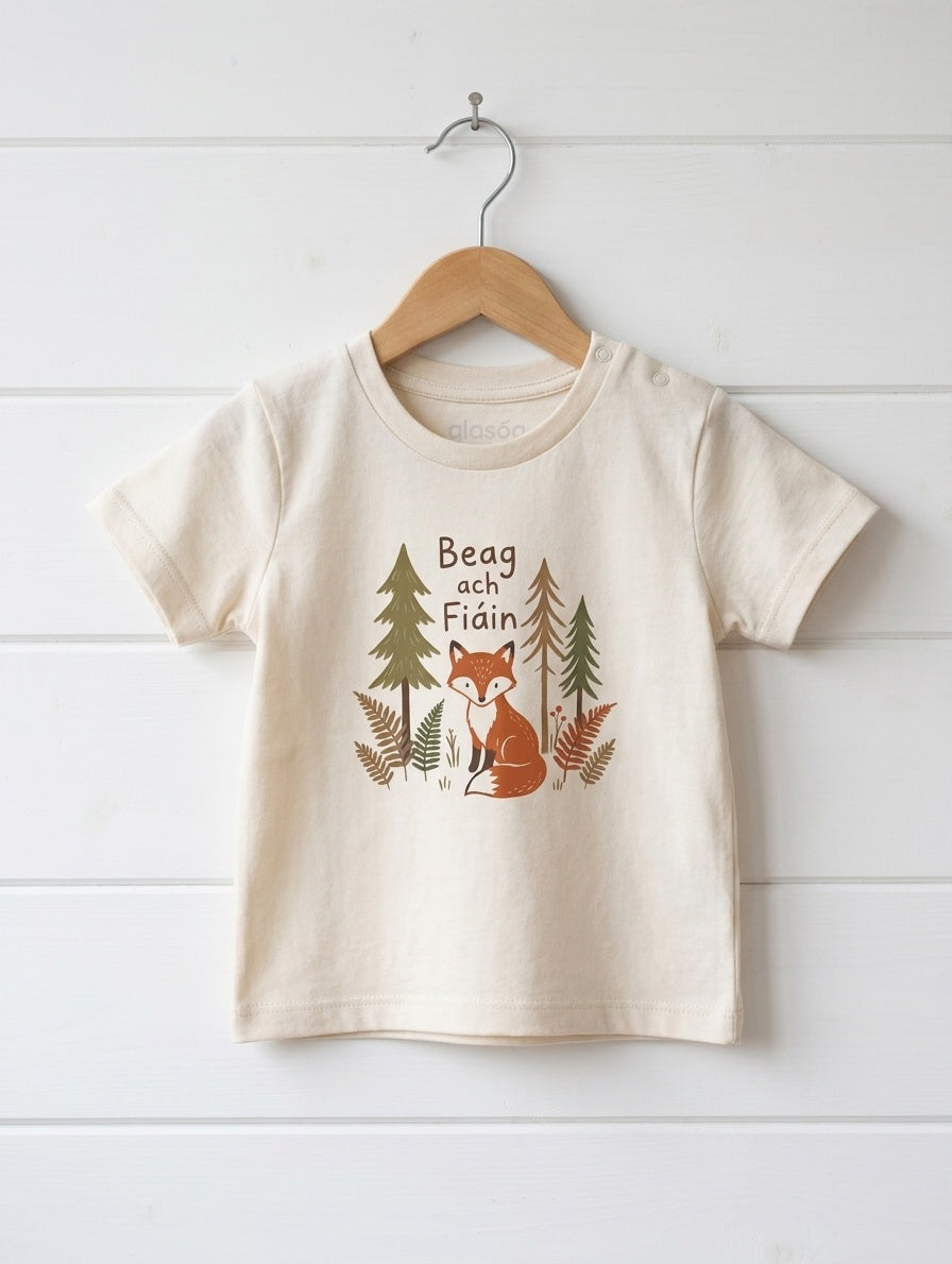 oatmeal kids t-shirt with beagfiain design hanging on wooden shiplap wall