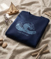 Flat lay of navy sweatshirt with wave design on natural leaf background