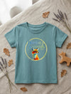 Flat lay of teal t-shirt with fox design on natural leaf background