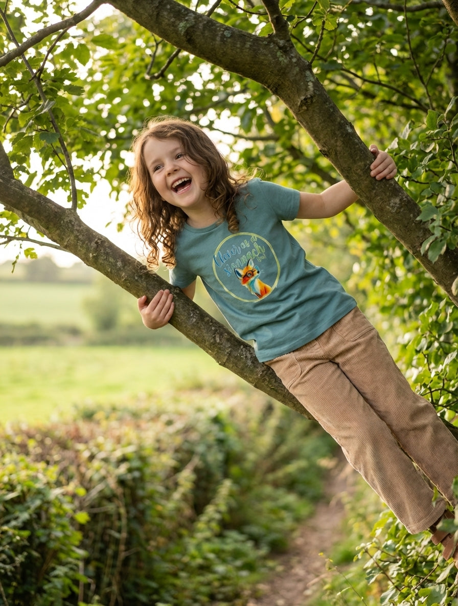 Styled editorial photo of teal kids t-shirt with fox illustration