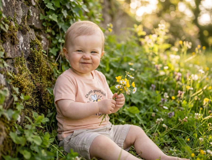 Styled editorial photo of peach kids t-shirt with bee illustration