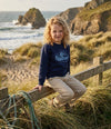 Styled editorial photo of navy kids sweatshirt with wave illustration
