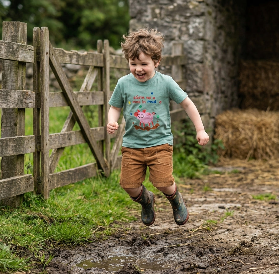 Child in motion wearing teal t-shirt with pig design