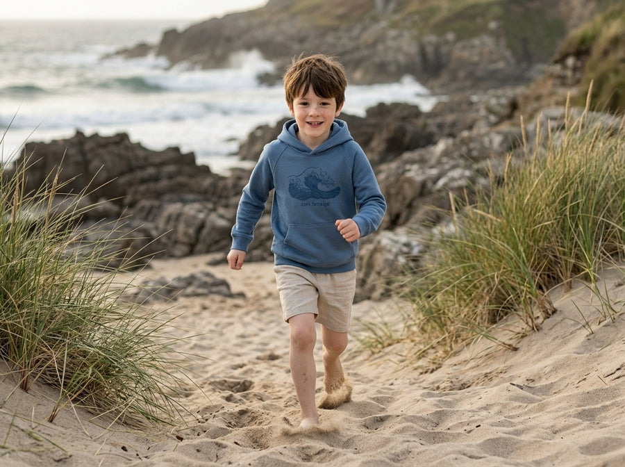 Child in motion wearing blue hoodie with wave design