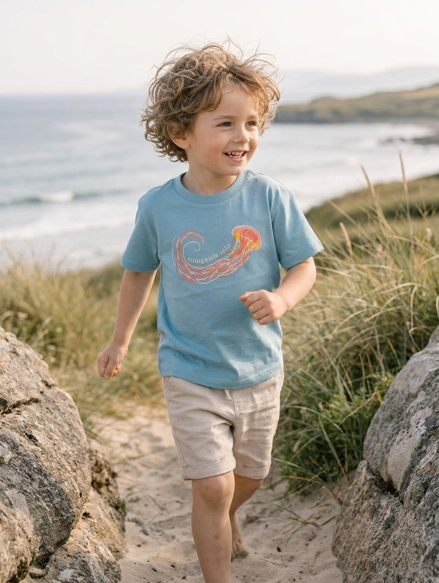 Child in motion wearing teal t-shirt with jellyfish design