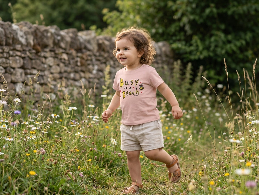 peach Baby Creator t-shirt with bee design — baby in motion wearing it