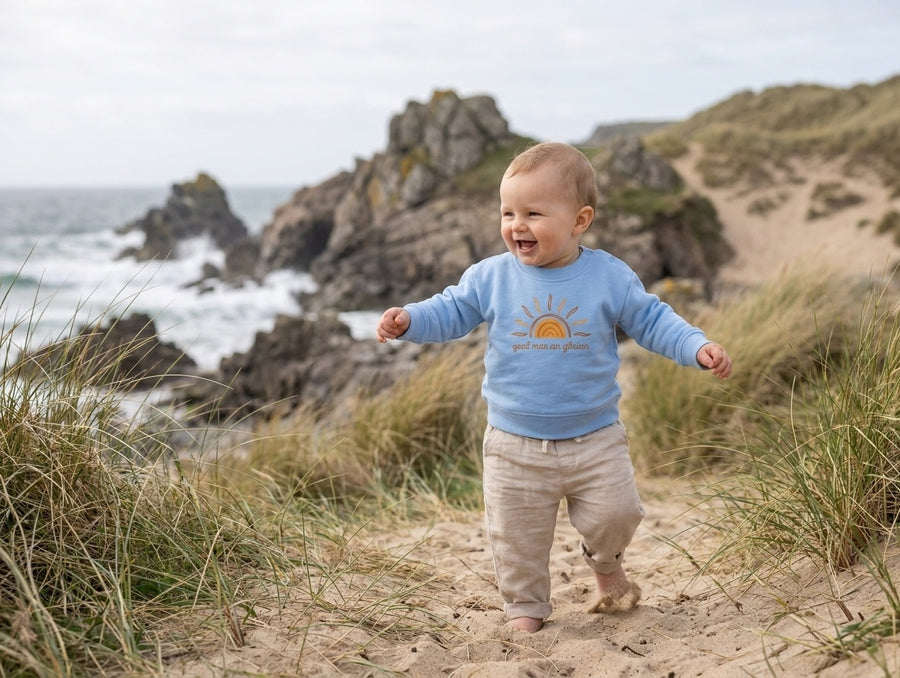 Child in motion wearing blue sweatshirt with sun design