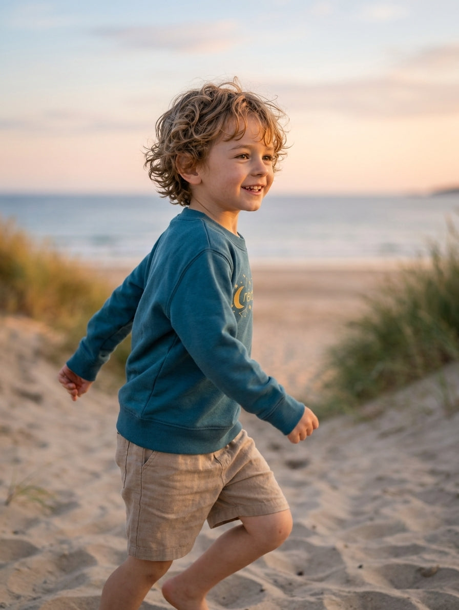 Child in motion wearing twilightblue sweatshirt with stars design