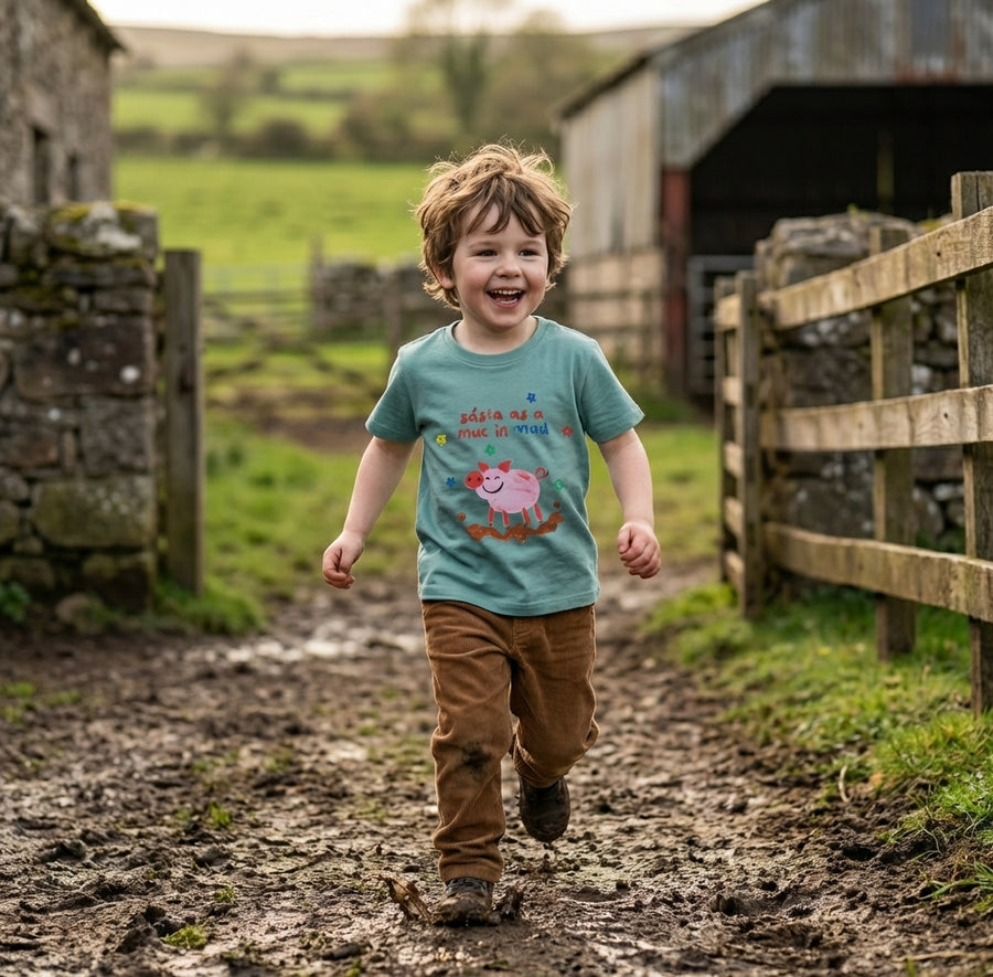 Child in motion wearing teal t-shirt with pig design