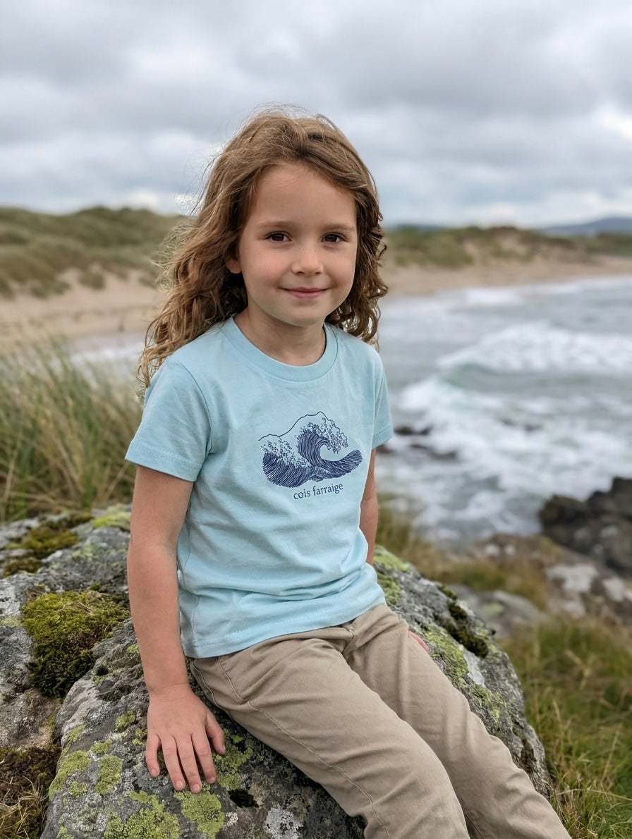 Child wearing poolblue t-shirt with wave design, portrait