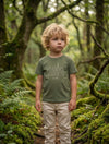 Child wearing green t-shirt with trees design, portrait