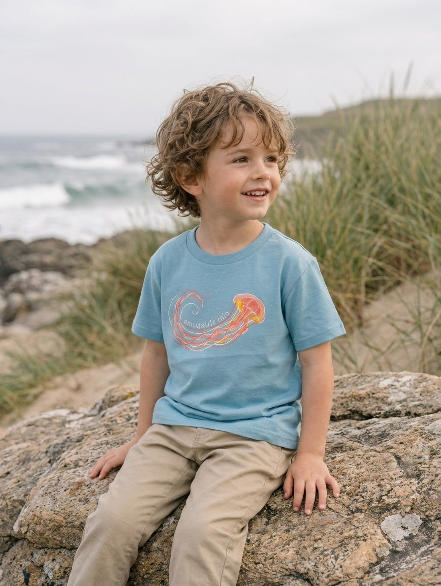 Child wearing teal t-shirt with jellyfish design, portrait