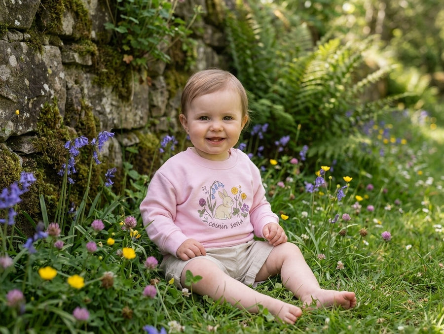 Child wearing pink sweatshirt with rabbit-floral design, portrait