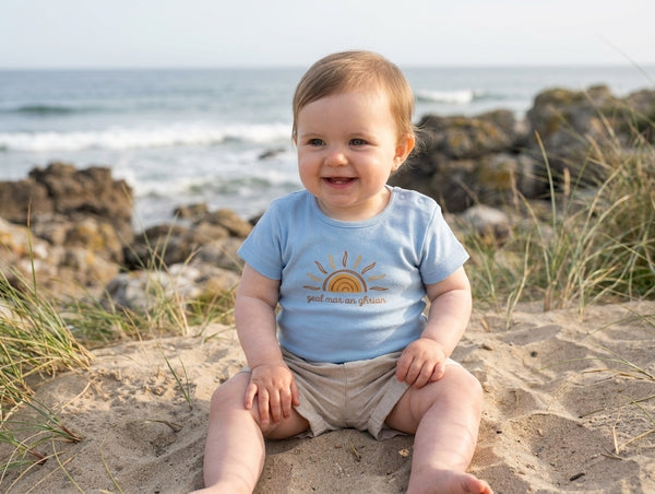 Child wearing blue bodysuit with sun design, portrait