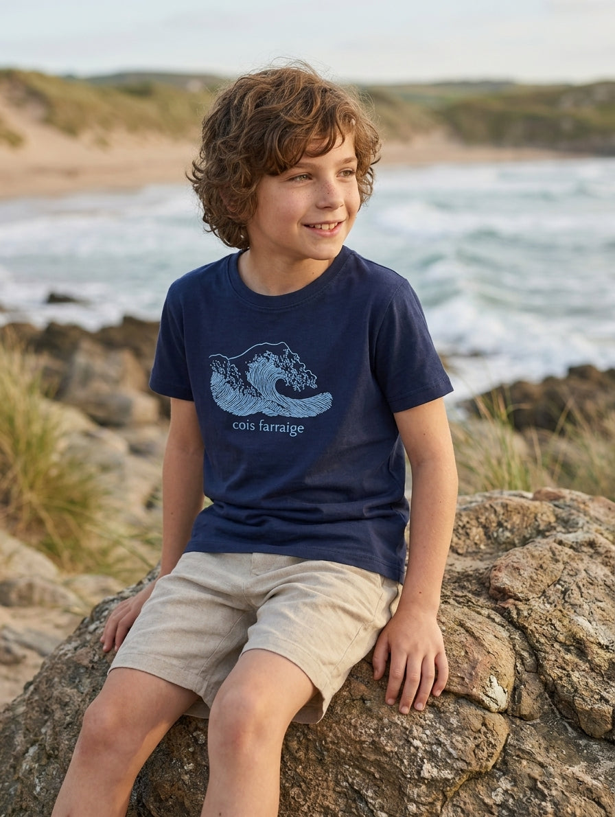 Child wearing navy t-shirt with wave design, portrait