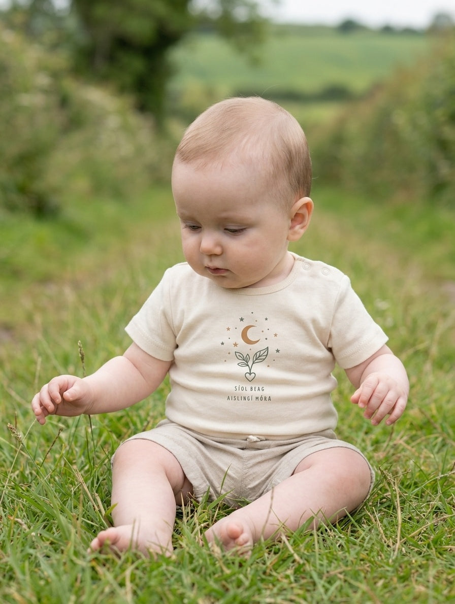 Child wearing cream bodysuit with seeddreams design, portrait
