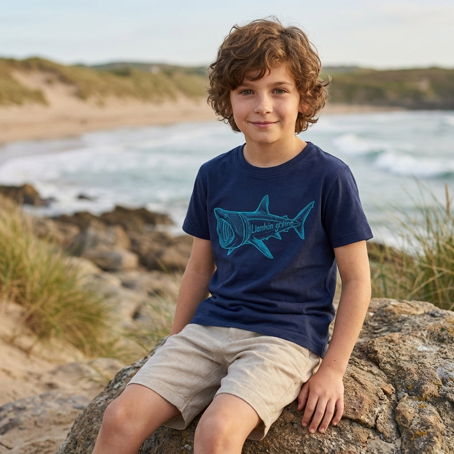 Child wearing blue t-shirt with shark design, portrait