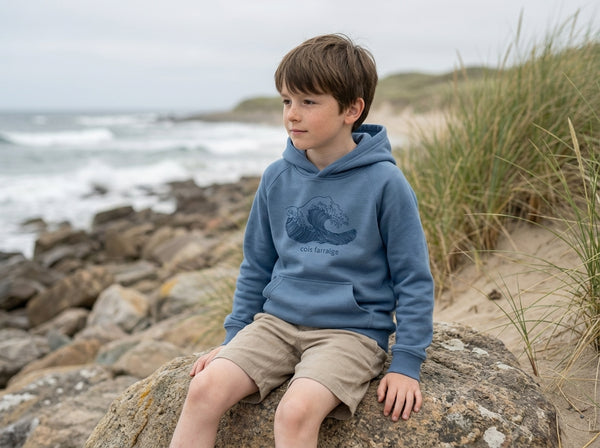 Child wearing blue hoodie with wave design, portrait