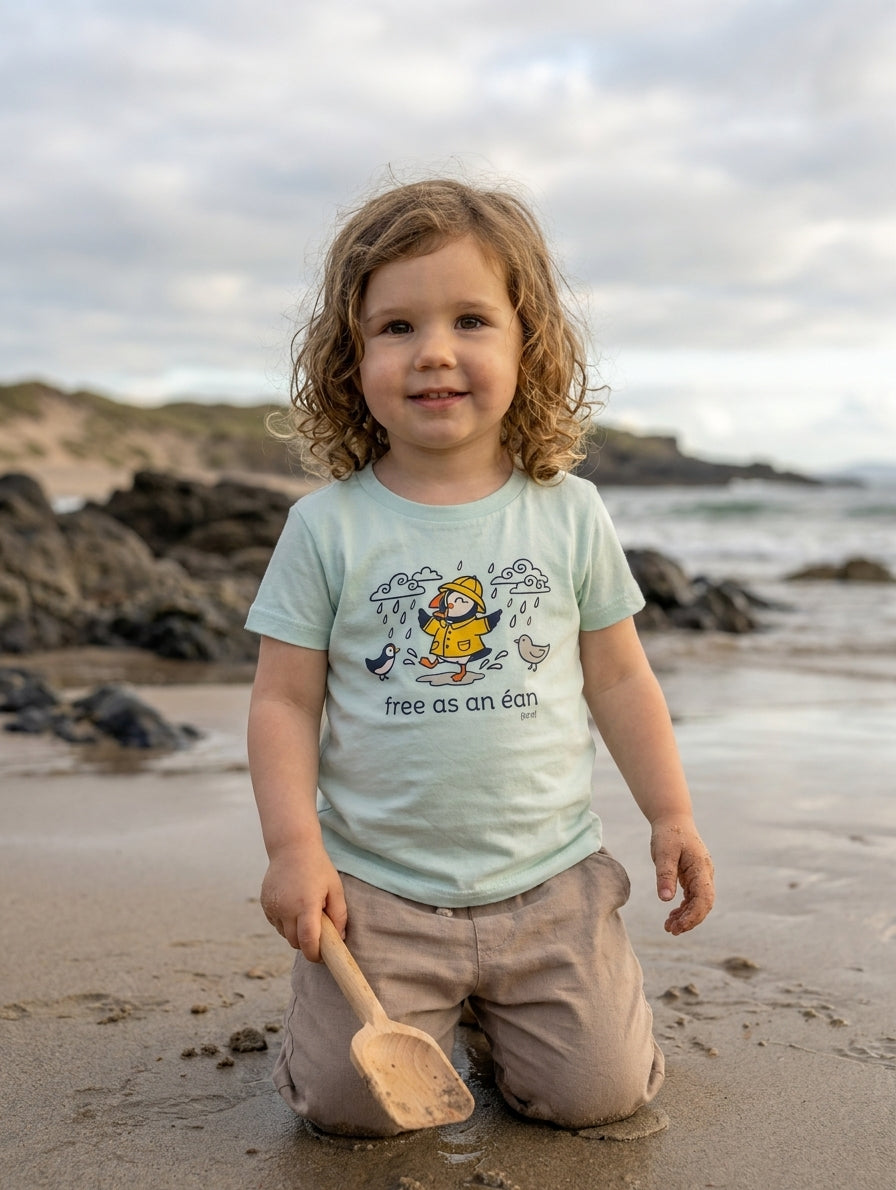 Child wearing blue t-shirt with puffin design, portrait