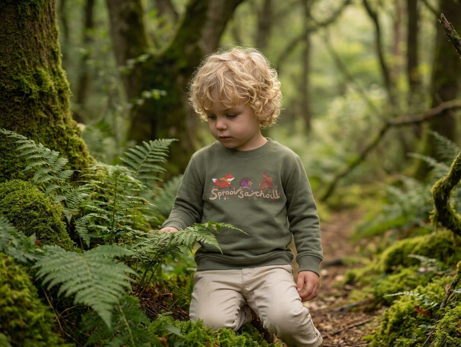 Child wearing khaki sweatshirt with spraoisachoill design, portrait