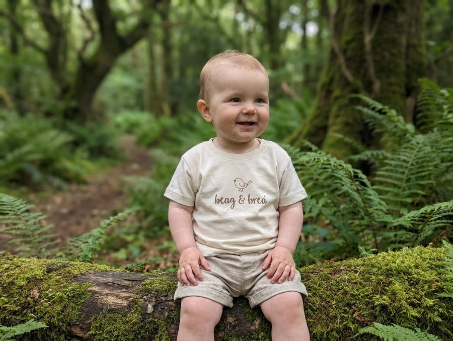 Child wearing oatmeal t-shirt with beagbrea design, portrait