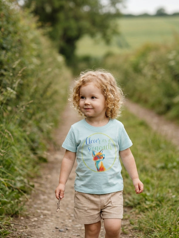 Baby wearing blue organic cotton t-shirt with fox design, portrait