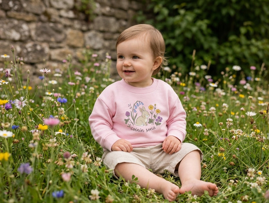 Child wearing pink sweatshirt with rabbit-floral design, portrait