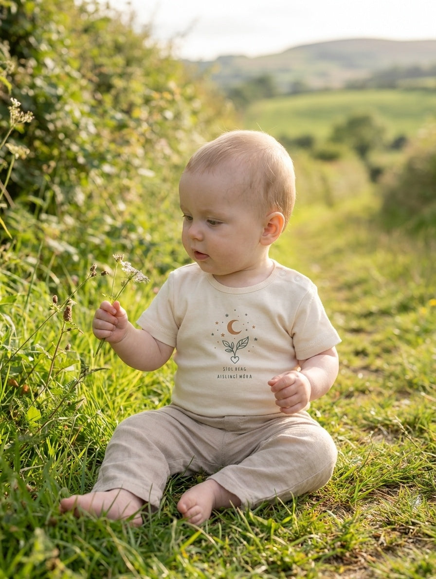 Child wearing cream bodysuit with seeddreams design, portrait