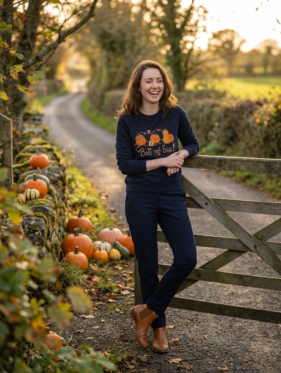 Woman wearing the navy Bob nó Bia adult sweatshirt leaning on a wooden gate
