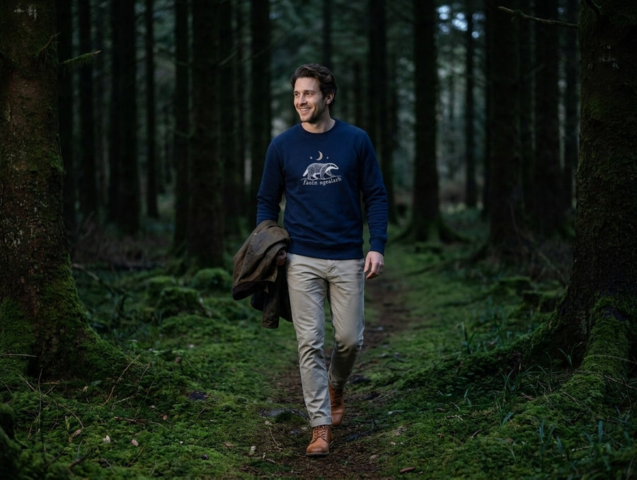 Man walking a mossy forest path in the navy Faoin nGealach adult sweatshirt