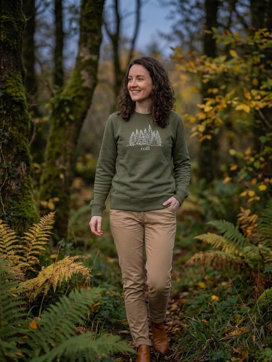 Woman walking through autumn woodland in the olive Coill adult sweatshirt